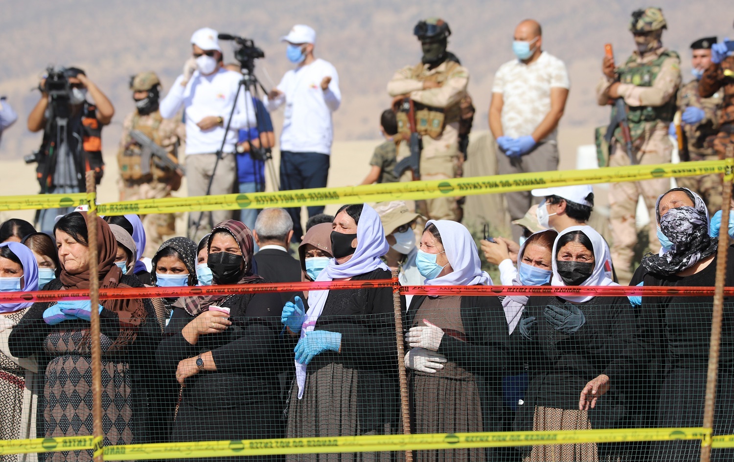 Yazidi women watch as a mass grave is exhumed in Solagh, Shingal on October 24, 2020. Photo: Fazel Hawramy/ Rudaw